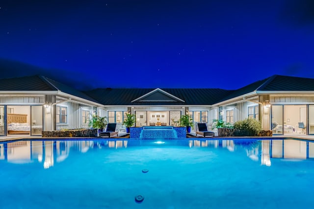 view of pool at twilight