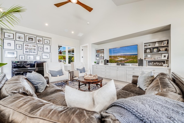 living room featuring built in shelves, ceiling fan, and high vaulted ceiling