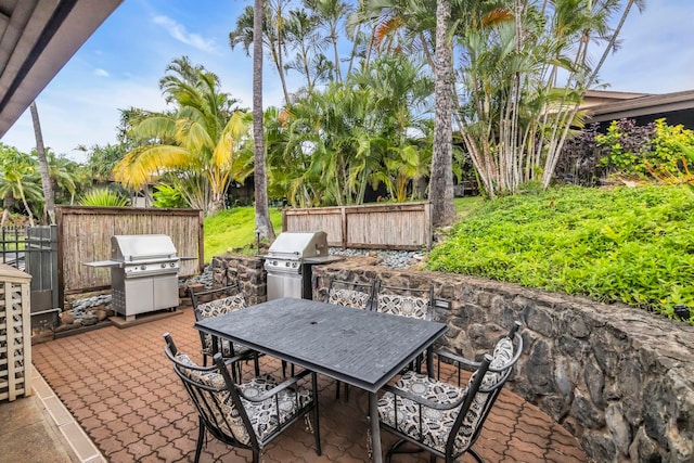 3788 Lower Honoapiilani Rd Unit A211, Lahaina, HI 96761 - view of patio / terrace featuring a grill, outdoor dining area, and fence