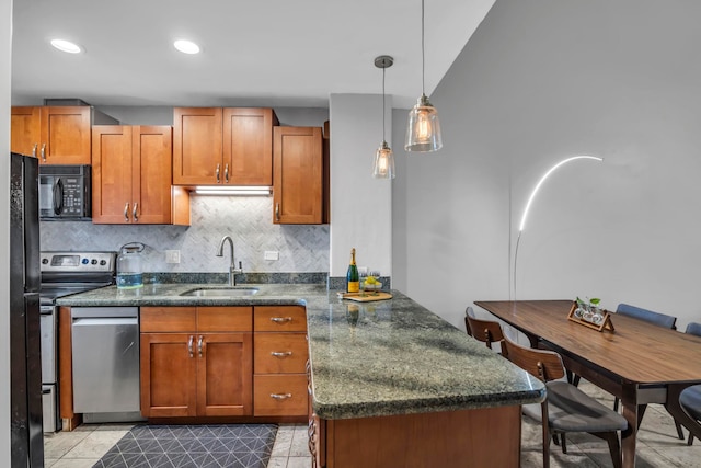 3788 Lower Honoapiilani Rd Unit A211, Lahaina, HI 96761 - kitchen featuring stainless steel appliances, a sink, a peninsula, backsplash, and brown cabinets