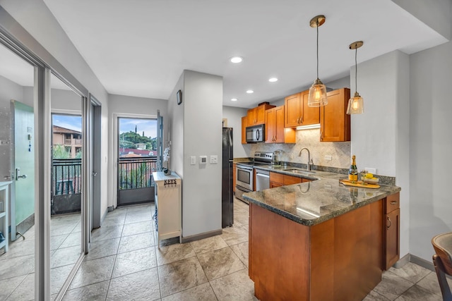 3788 Lower Honoapiilani Rd Unit A211, Lahaina, HI 96761 - kitchen with black appliances, a sink, baseboards, brown cabinetry, and dark stone counters