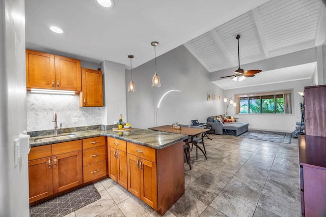 3788 Lower Honoapiilani Rd Unit A211, Lahaina, HI 96761 - kitchen with a sink, a peninsula, brown cabinets, open floor plan, and a ceiling fan