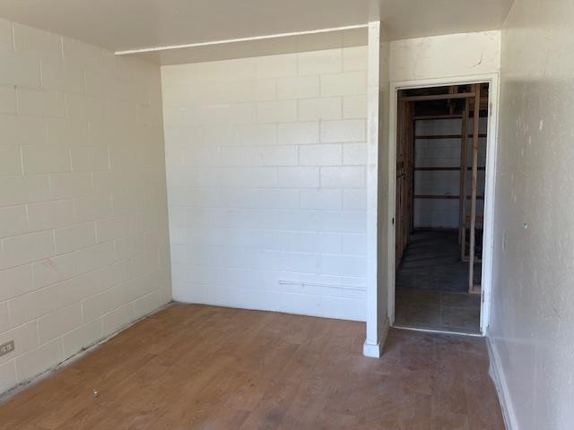 111 Kahului Beach Rd Unit A127, Kahului, HI 96732 - empty room featuring wood finished floors and concrete block wall
