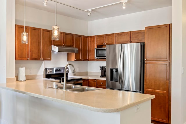 kitchen featuring light countertops, appliances with stainless steel finishes, brown cabinets, and under cabinet range hood