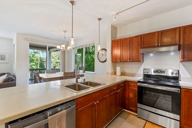 kitchen with stainless steel appliances, a sink, light countertops, and under cabinet range hood