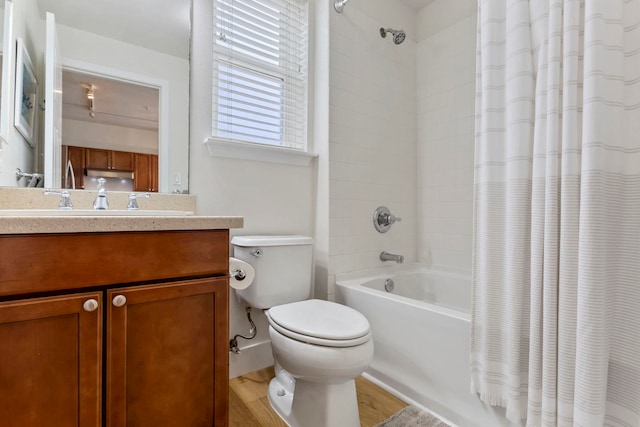 full bath featuring vanity, wood finished floors, shower / bath combination with curtain, and toilet