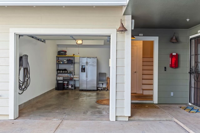 garage with stainless steel fridge with ice dispenser