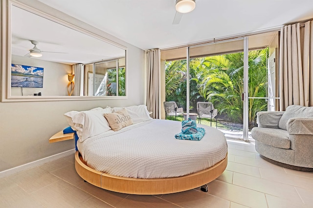 bedroom featuring baseboards, multiple windows, tile patterned floors, and floor to ceiling windows