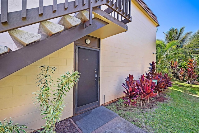 entrance to property featuring concrete block siding