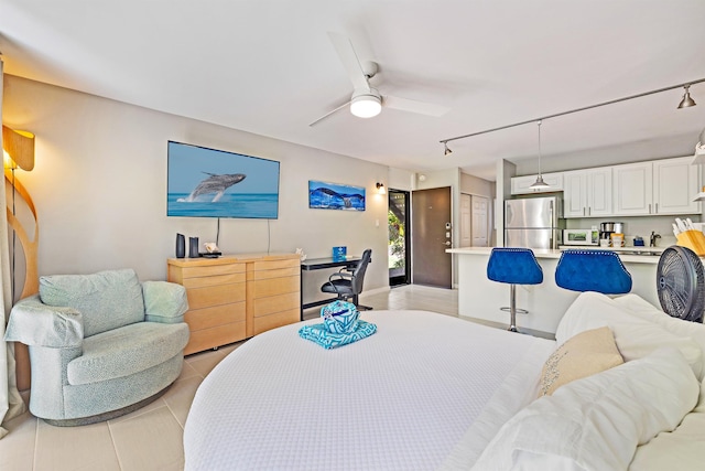 bedroom featuring ceiling fan, light tile patterned flooring, and freestanding refrigerator