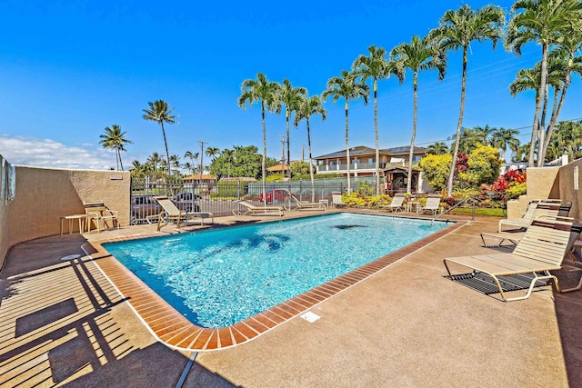 pool featuring a patio and fence