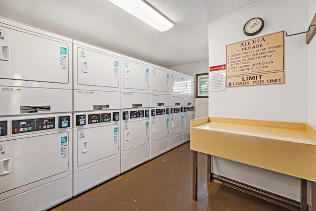 common laundry area with stacked washer / dryer and mail area