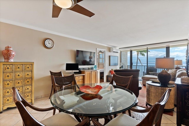 tiled dining space with ceiling fan, crown molding, a wall of windows, and a wall unit AC