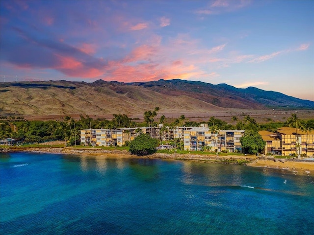 exterior space with a water and mountain view