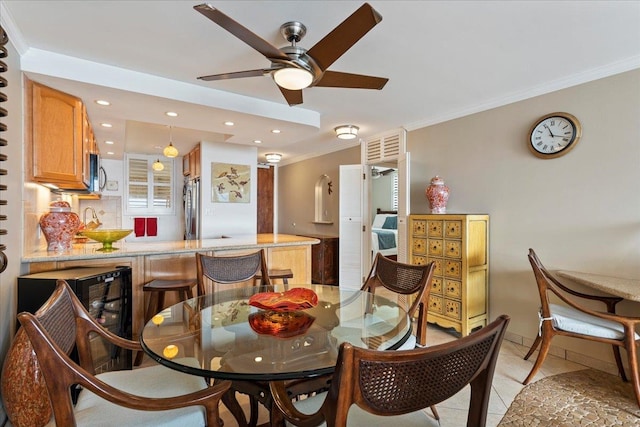 tiled dining space with ornamental molding and ceiling fan