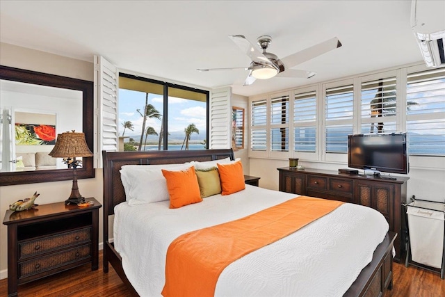 bedroom with ceiling fan and dark hardwood / wood-style flooring