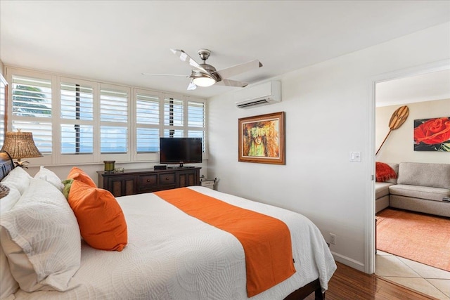 bedroom featuring multiple windows, tile floors, ceiling fan, and a wall unit AC