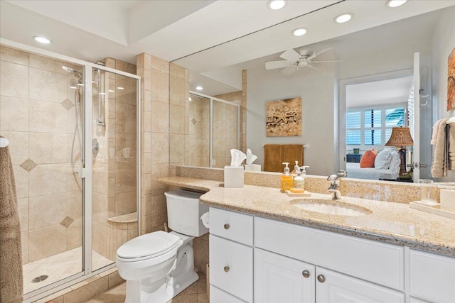 bathroom featuring toilet, ceiling fan, a shower with door, tile flooring, and large vanity