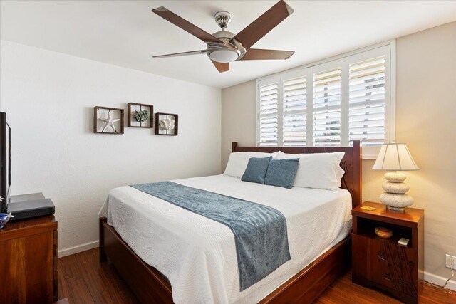 bedroom with ceiling fan and dark wood-type flooring