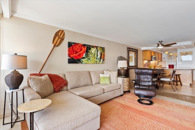 living room featuring ornamental molding and ceiling fan