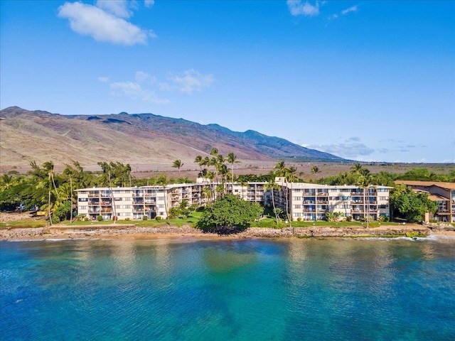 birds eye view of property with a water and mountain view