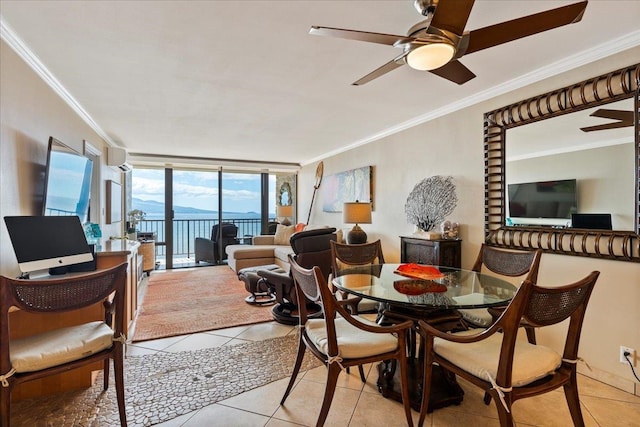 dining area with ceiling fan, crown molding, and light tile floors