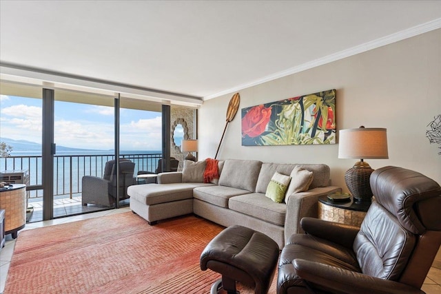 living room featuring expansive windows, a water view, ornamental molding, and light tile floors