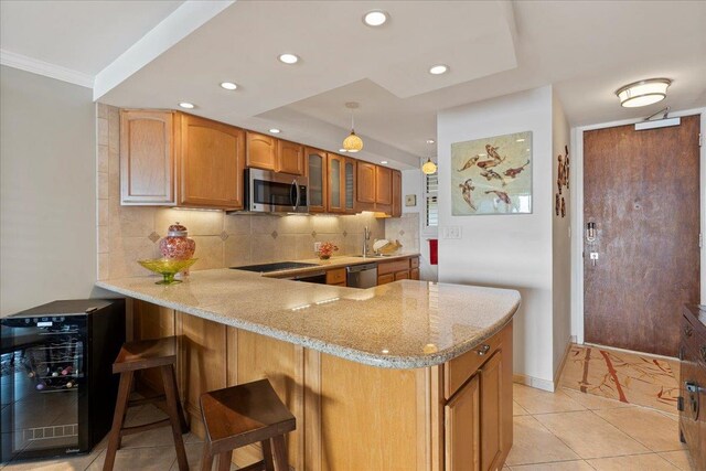 kitchen featuring wine cooler, a breakfast bar, light tile floors, and appliances with stainless steel finishes