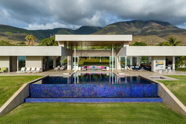 exterior space with an outdoor living space, a mountain view, a yard, and a patio