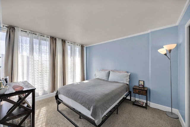 bedroom featuring crown molding and carpet