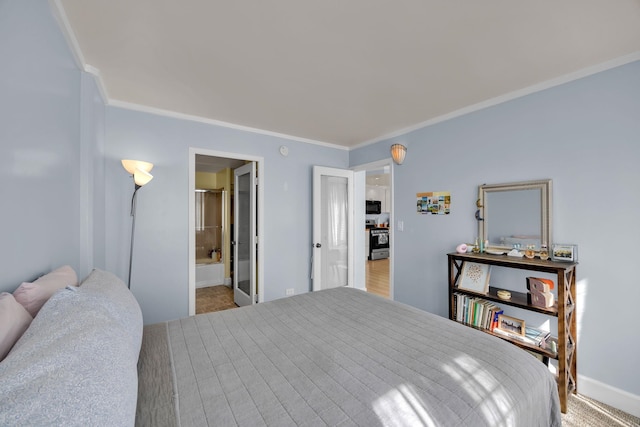 carpeted bedroom with ensuite bathroom and crown molding