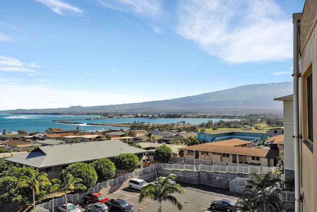 exterior space with a water and mountain view