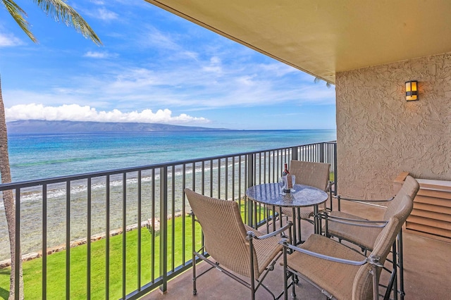 balcony with a view of the beach and a water view