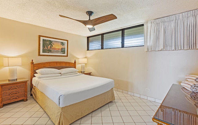 bedroom with light tile patterned flooring, a ceiling fan, and a textured ceiling