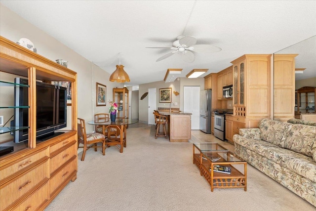 living room featuring ceiling fan, sink, light carpet, and a textured ceiling