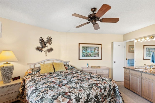 bedroom with light carpet, a textured ceiling, ceiling fan, and sink