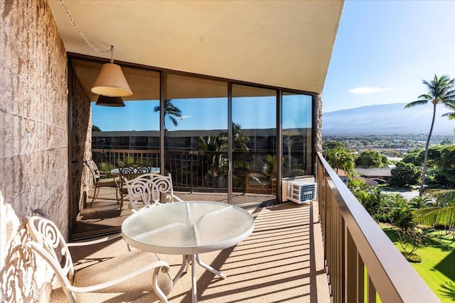 balcony featuring a mountain view and cooling unit