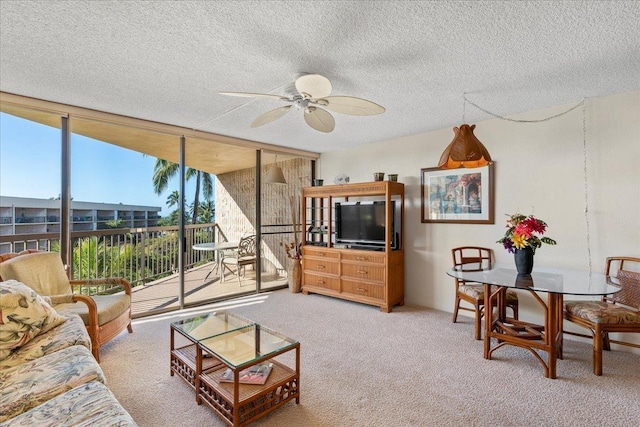 carpeted living room with a textured ceiling, expansive windows, and ceiling fan