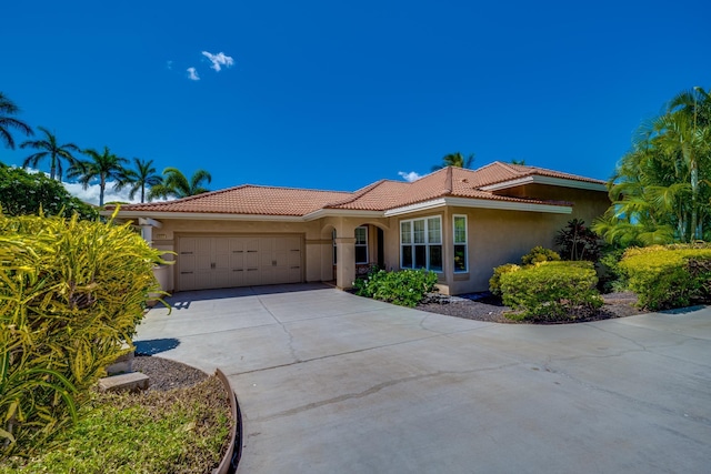 2177 Hihimanu St Unit 121, Kihei, HI 96753 - mediterranean / spanish house featuring a garage