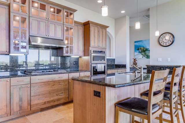 2177 Hihimanu St Unit 121, Kihei, HI 96753 - kitchen with a kitchen breakfast bar, sink, tasteful backsplash, an island with sink, and stainless steel appliances