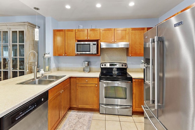 kitchen with stainless steel appliances, sink, and light tile patterned floors