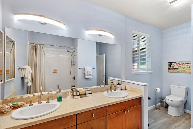 bathroom featuring vanity, toilet, a shower with shower curtain, and hardwood / wood-style floors