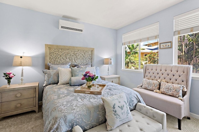 bedroom with a wall unit AC and light carpet