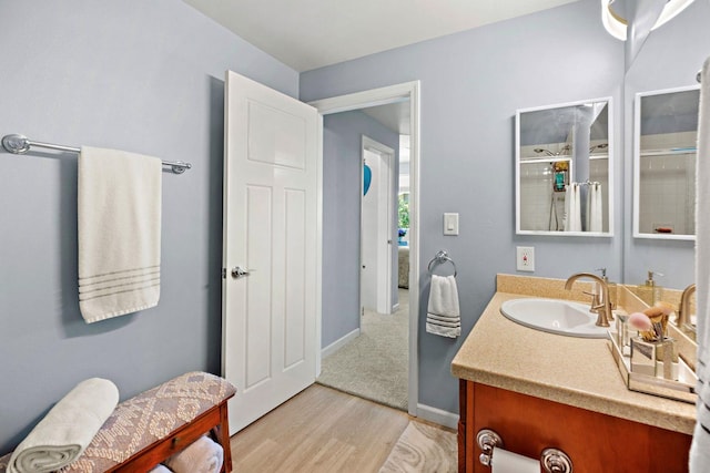 bathroom with vanity, hardwood / wood-style floors, and an enclosed shower