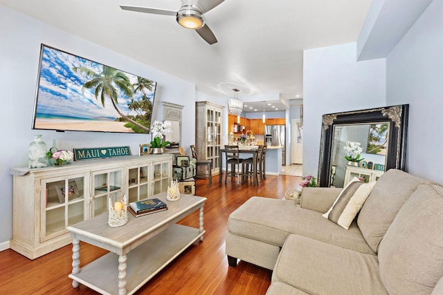 living room featuring ceiling fan and dark hardwood / wood-style flooring