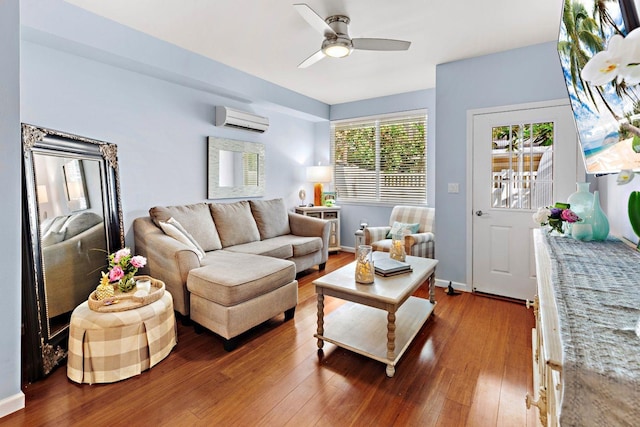 living room featuring a wall mounted AC, ceiling fan, and dark hardwood / wood-style flooring