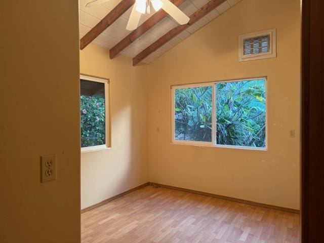 unfurnished room featuring light wood-type flooring, ceiling fan, and vaulted ceiling with beams