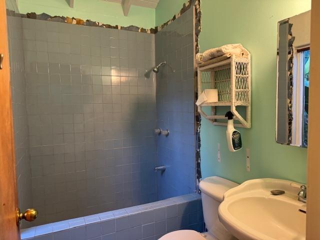 full bathroom featuring sink, toilet, and tiled shower / bath combo