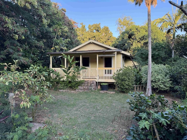 view of front of home with covered porch and a front yard