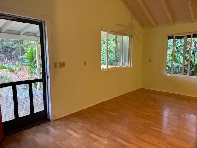 interior space with light hardwood / wood-style flooring, vaulted ceiling with beams, and wooden ceiling